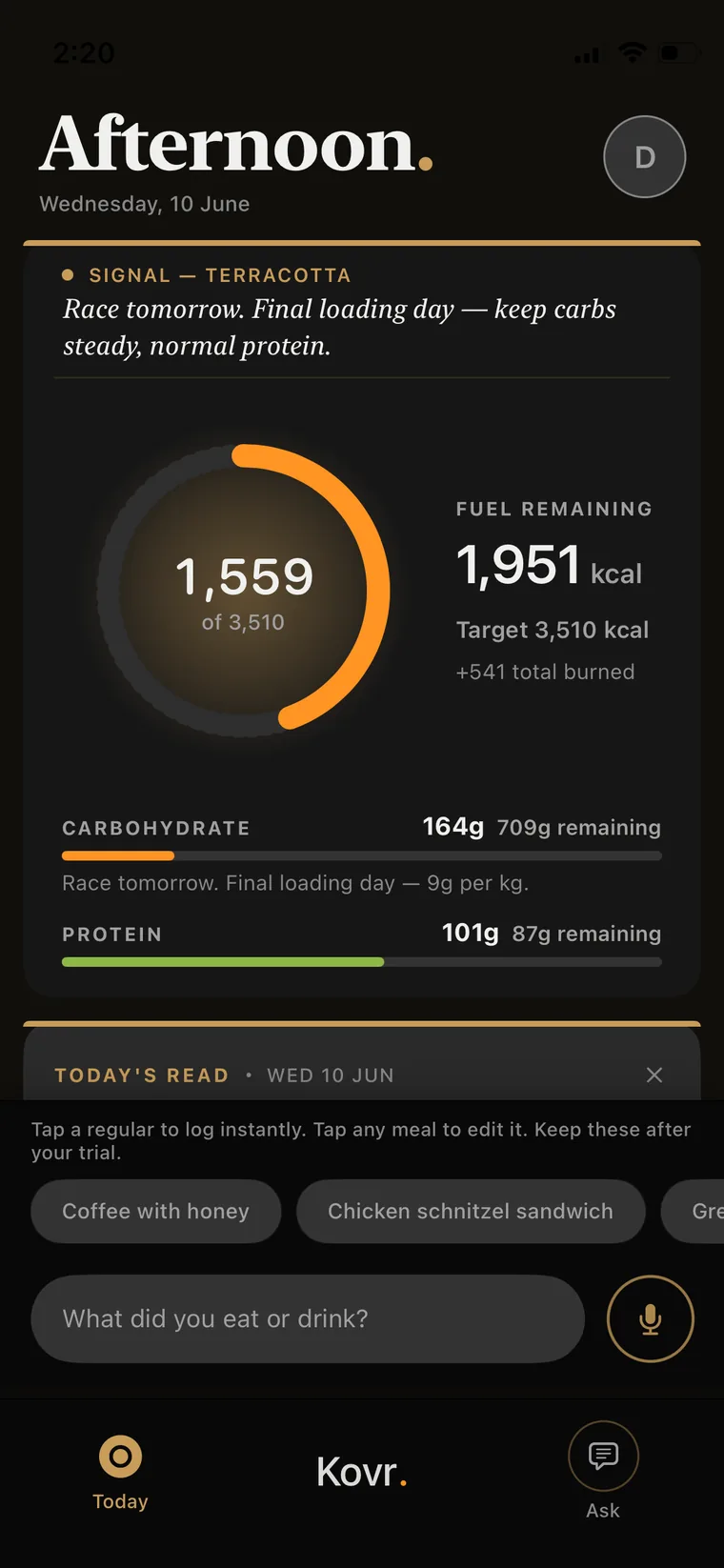 Kovr Today view in the app, headed Afternoon, Wednesday 10 June. The Signal reads terracotta with a race-tomorrow note to keep carbs steady and protein normal. A fuel ring shows 1,559 of 3,510 kcal with 1,951 remaining; carbohydrate 164g and protein 101g, on a final loading day at 9g per kg.